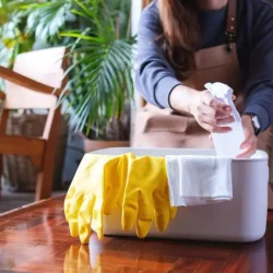 7d11b-a-young-woman-picking-spray-bottle-up-from-a-clean-2023-11-27-05-10-09-utc-1024x576